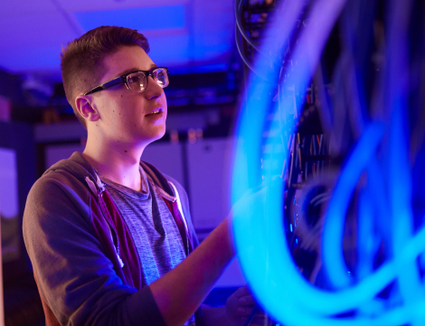 boy learning about computer technician with cables