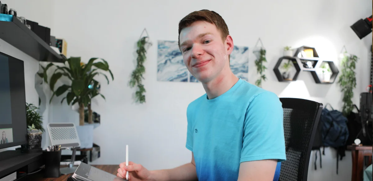 High school student taking notes during an online class